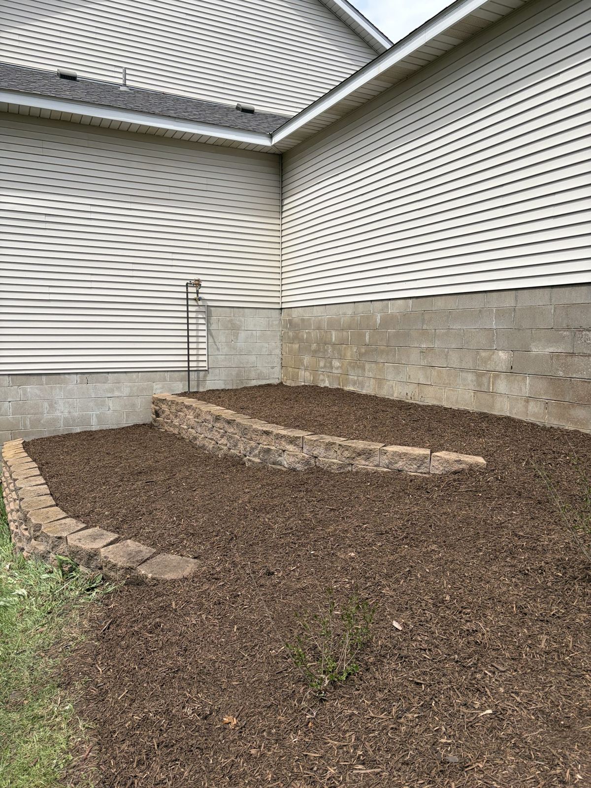 A cleaned and freshly mulched bed — a real NLL project